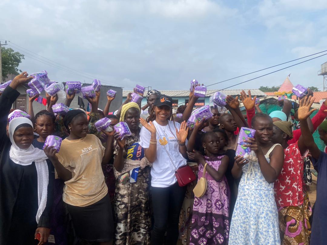 Arieli Foundation sanitary pad distribution outreach - community members celebrating with menstrual hygiene products